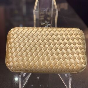 Gold silk weaved clutch comes with strap